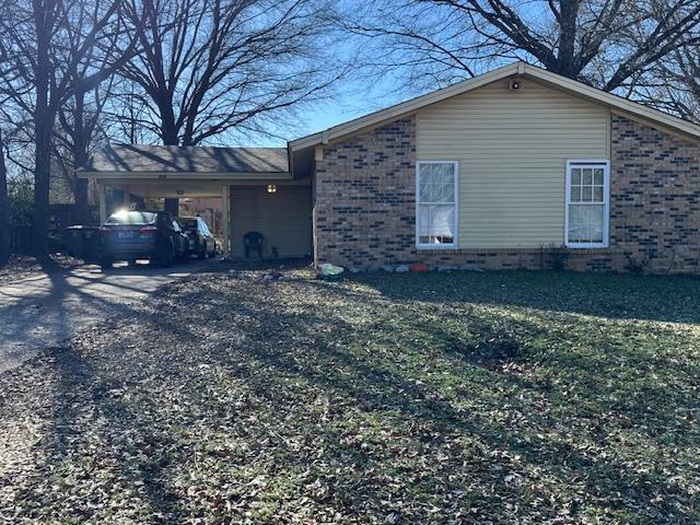 view of side of home featuring a carport