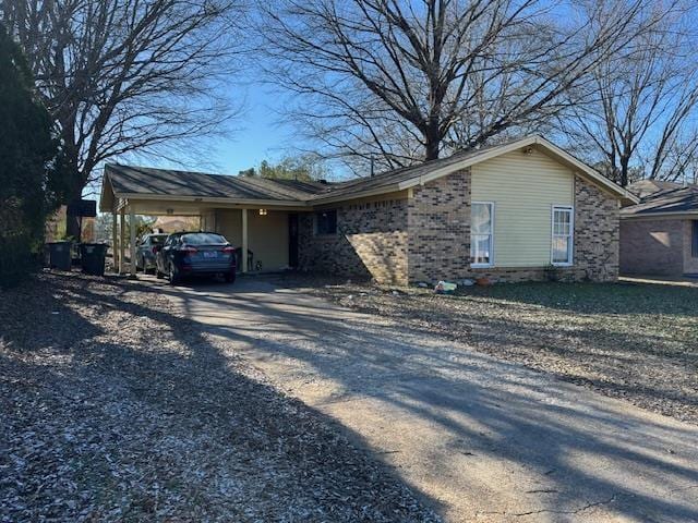 ranch-style home featuring a carport