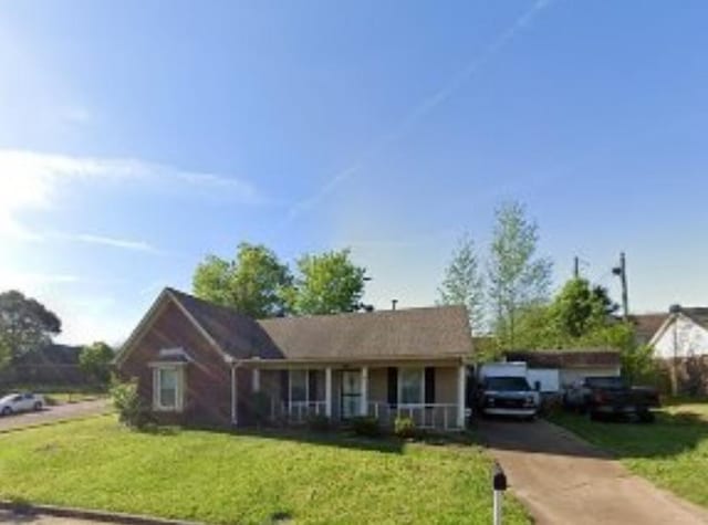 view of front of home with covered porch and a front yard