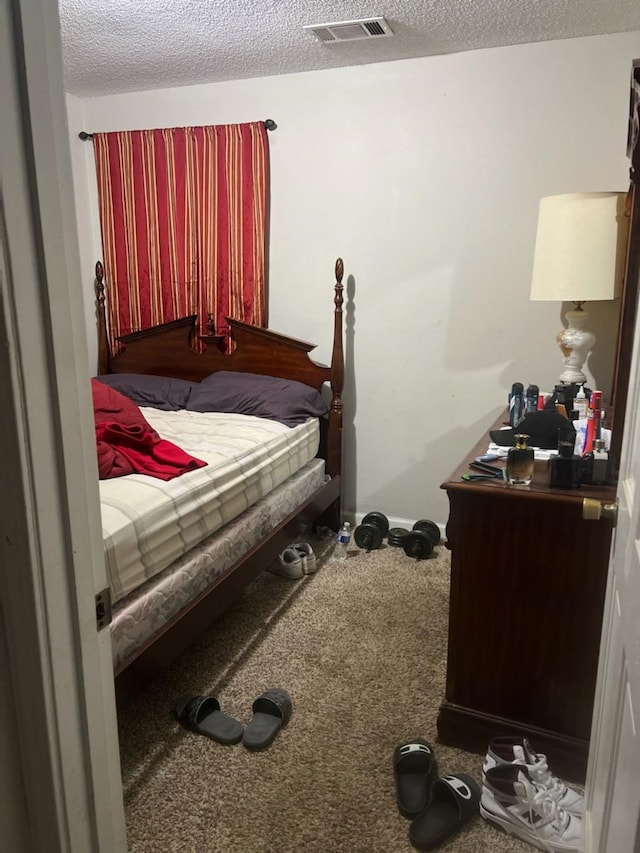 carpeted bedroom with a textured ceiling