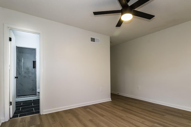 empty room with dark wood-type flooring and ceiling fan