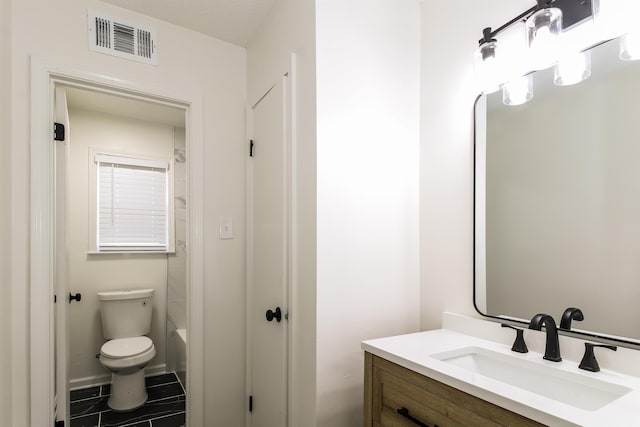 bathroom with tile patterned flooring, vanity, and toilet