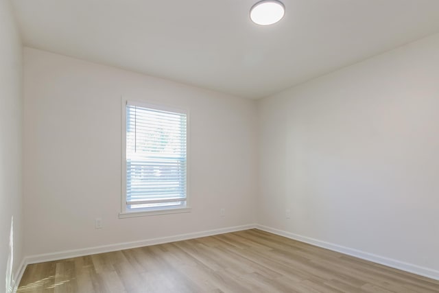 unfurnished room with light wood-type flooring