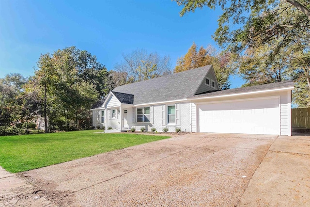 view of front of house with a garage and a front yard