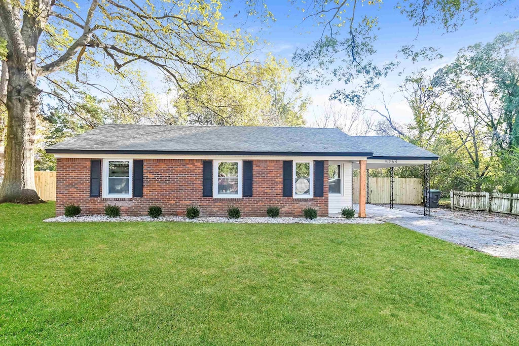 single story home featuring a front yard and a carport