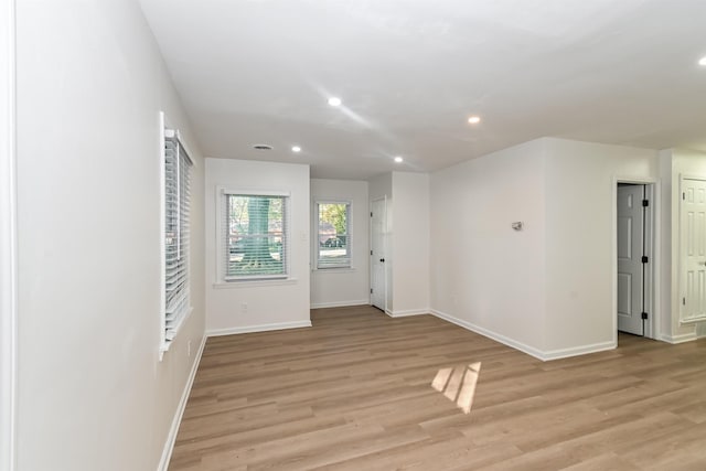 empty room with light hardwood / wood-style flooring