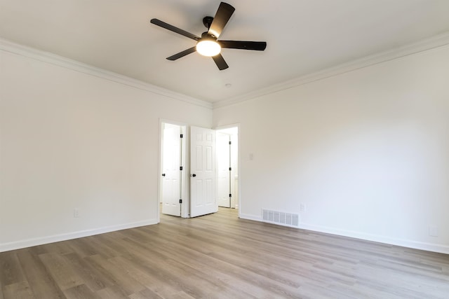 spare room with ornamental molding, light hardwood / wood-style floors, and ceiling fan