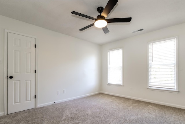 spare room with ceiling fan and carpet flooring