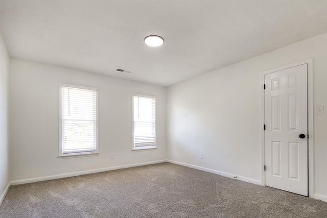 unfurnished room featuring carpet