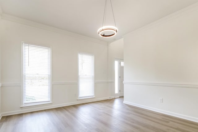 unfurnished room with crown molding and wood-type flooring