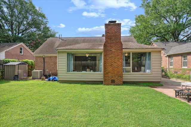 back of property with a storage shed, a yard, central AC unit, and a patio