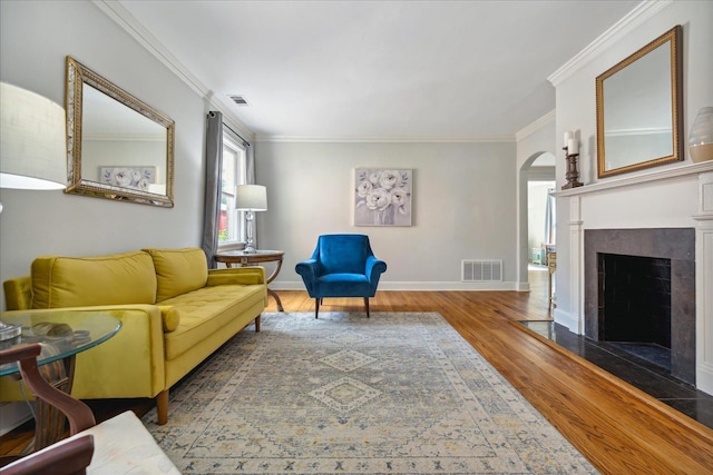 living room with ornamental molding and hardwood / wood-style floors