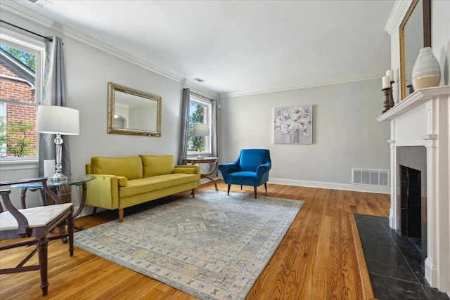 living room featuring crown molding, plenty of natural light, and wood-type flooring