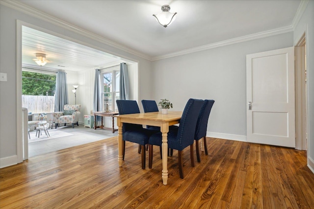 dining space featuring ornamental molding and hardwood / wood-style floors