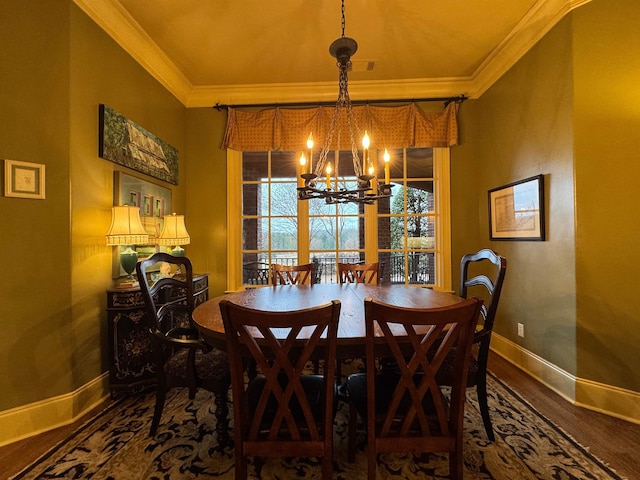 dining room with crown molding, wood-type flooring, and an inviting chandelier