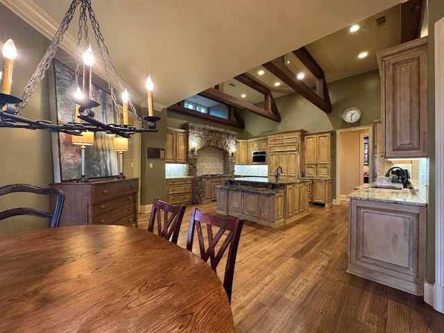 dining room with sink, hardwood / wood-style flooring, and a towering ceiling