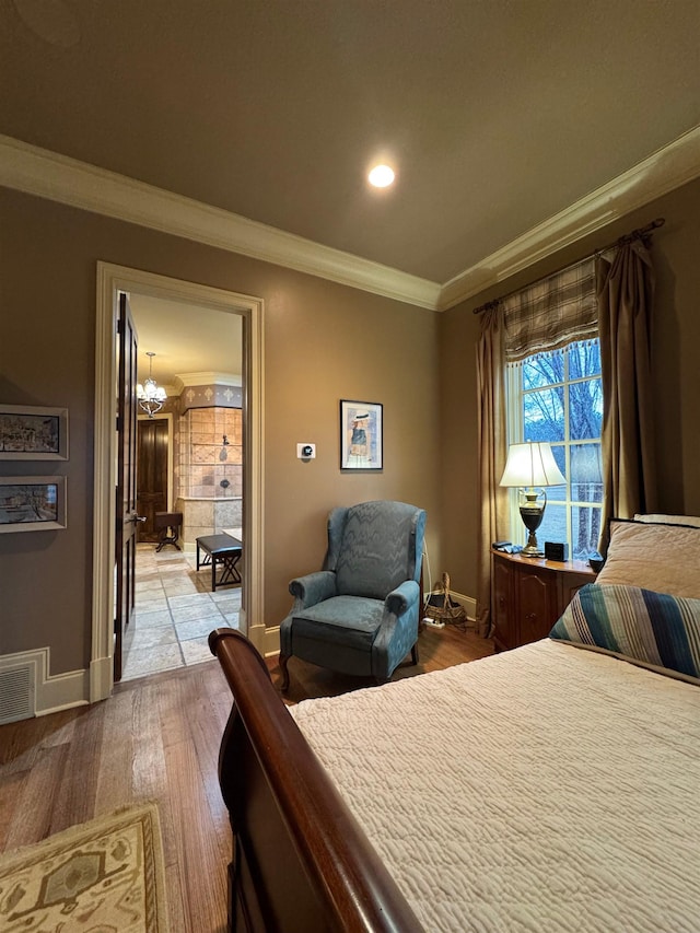 bedroom with ornamental molding and light hardwood / wood-style floors