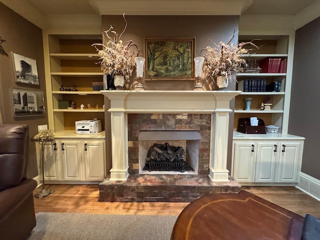 interior space featuring built in shelves and light hardwood / wood-style floors