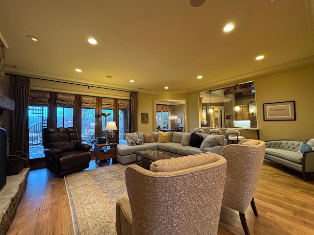 living room with hardwood / wood-style floors and ornamental molding