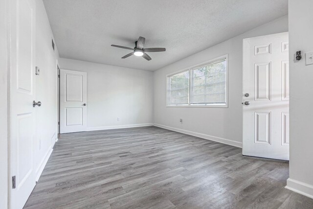 spare room featuring ceiling fan, hardwood / wood-style floors, and a textured ceiling