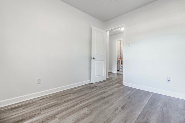 spare room with light hardwood / wood-style flooring