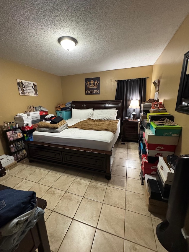 bedroom with light tile patterned floors and a textured ceiling