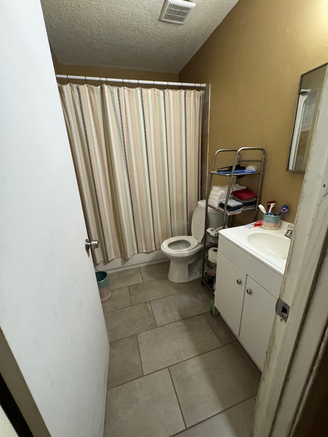 full bathroom with tile patterned floors, toilet, shower / tub combo, a textured ceiling, and vanity