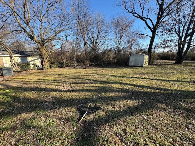 view of yard featuring central AC and a shed