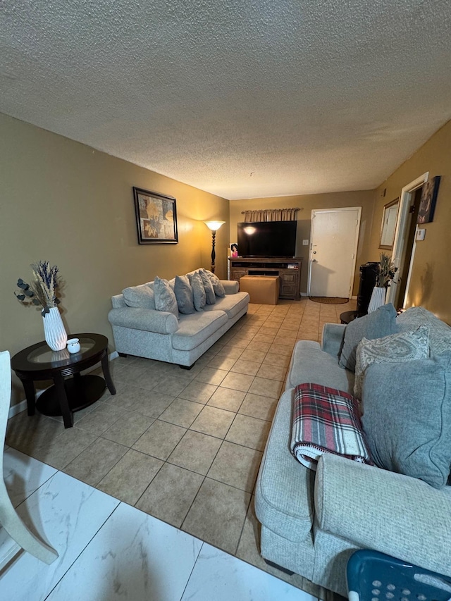 tiled living room featuring a textured ceiling