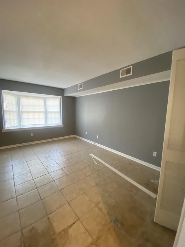 unfurnished room with light tile patterned floors