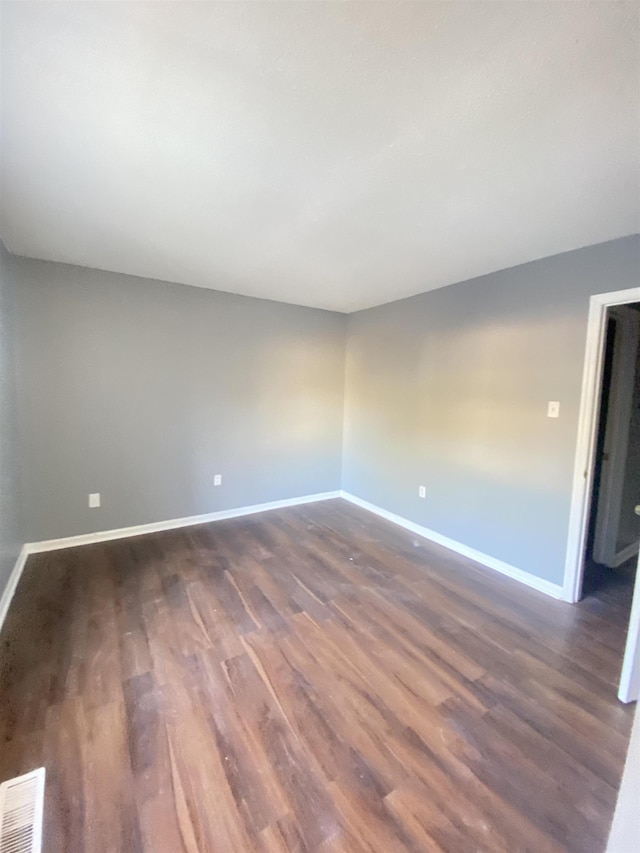 unfurnished room with dark hardwood / wood-style floors