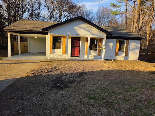 view of front of property with a porch and a carport