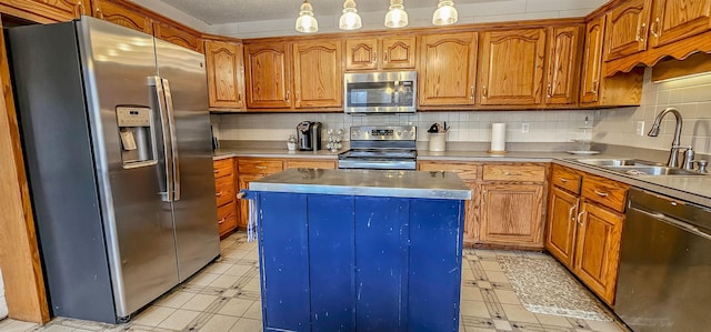 kitchen with appliances with stainless steel finishes, a center island, sink, and backsplash