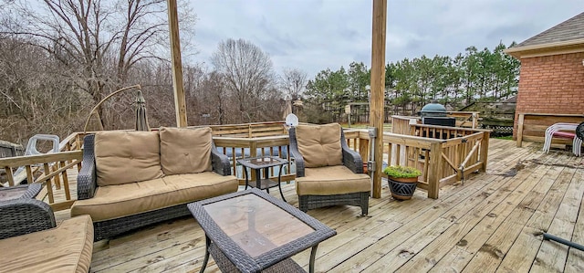 wooden deck with an outdoor living space and grilling area