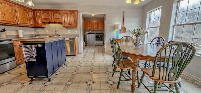 kitchen with tasteful backsplash, sink, washing machine and dryer, and stainless steel electric range