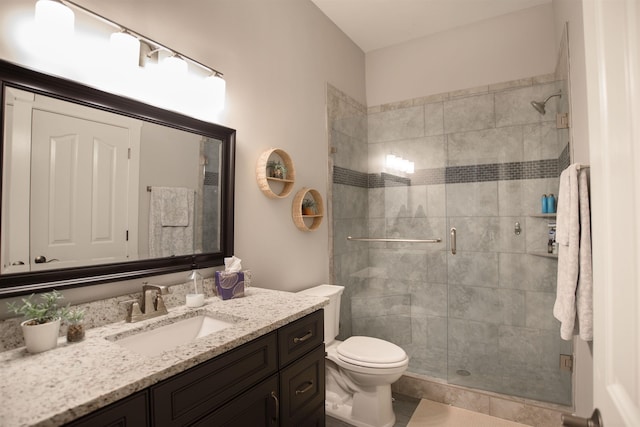 bathroom with vanity, an enclosed shower, and toilet