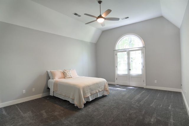 bedroom featuring dark colored carpet, lofted ceiling, and ceiling fan