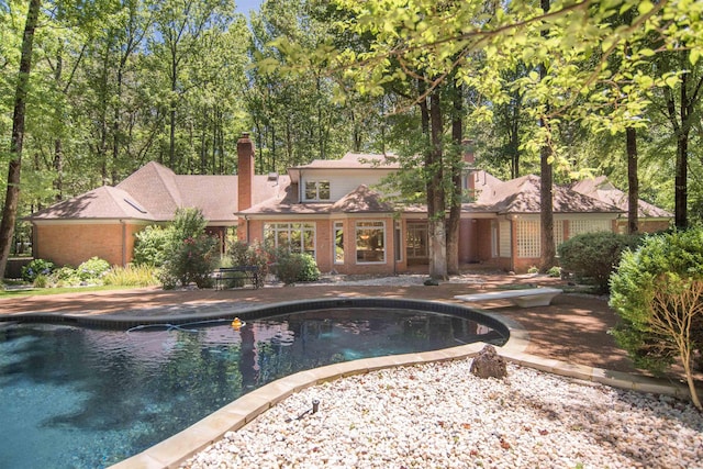 view of pool featuring a diving board