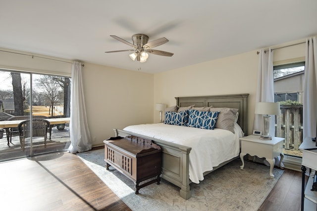 bedroom with hardwood / wood-style floors, access to outside, and ceiling fan