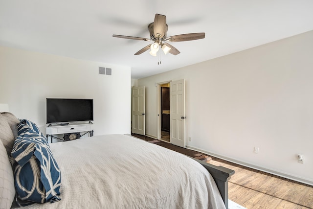 bedroom with ceiling fan and wood-type flooring