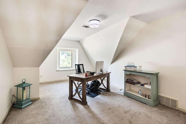 carpeted office space with vaulted ceiling