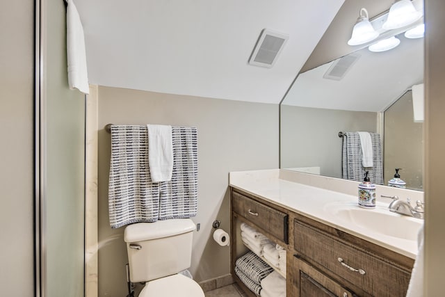 bathroom with vanity, toilet, and walk in shower