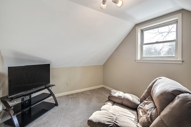 sitting room with vaulted ceiling and carpet flooring