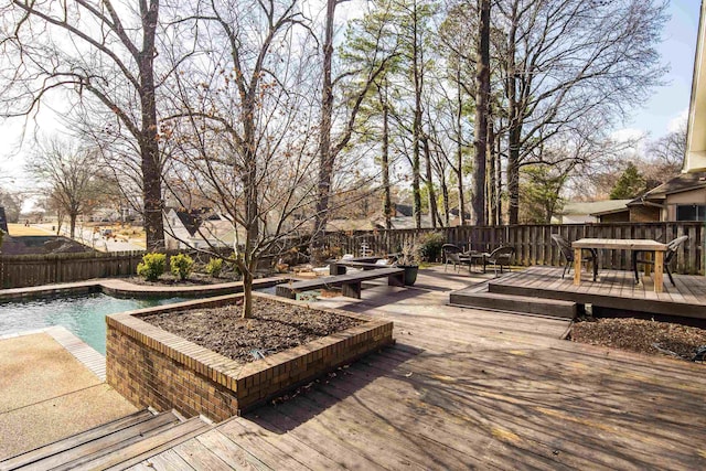 wooden terrace featuring a fenced in pool