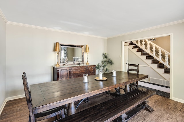 dining area featuring hardwood / wood-style floors and crown molding