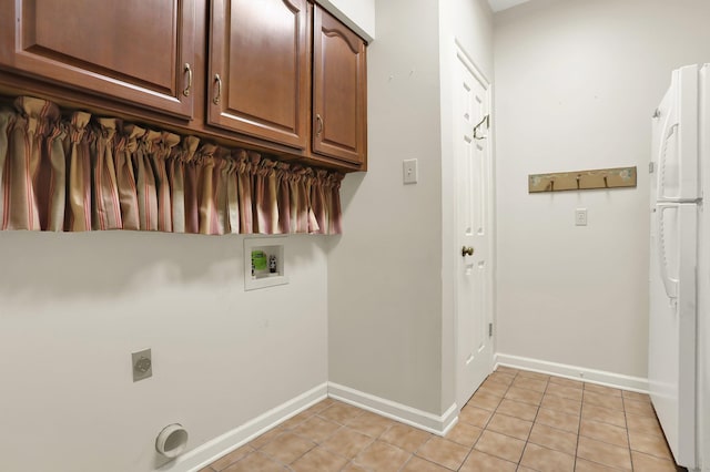 laundry room featuring hookup for a washing machine, light tile patterned floors, and cabinets