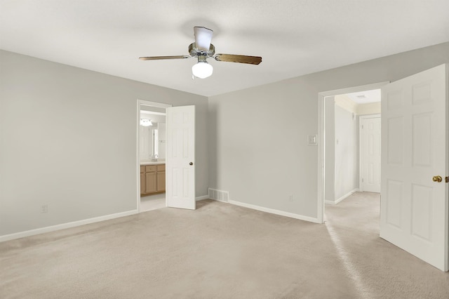 unfurnished bedroom with ceiling fan and ensuite bath