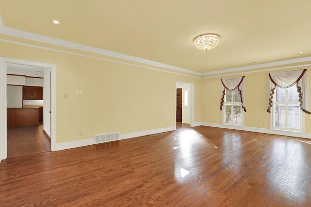 unfurnished room featuring hardwood / wood-style flooring and ornamental molding