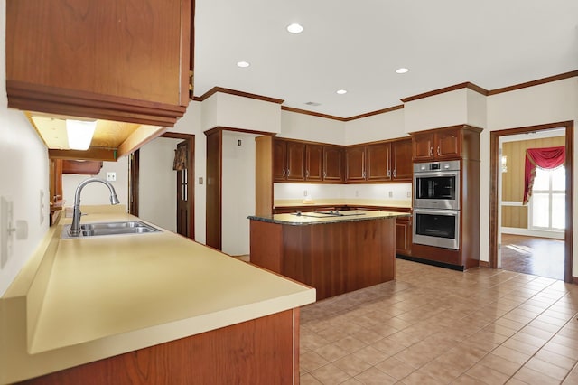 kitchen featuring double oven, sink, crown molding, and light tile patterned floors