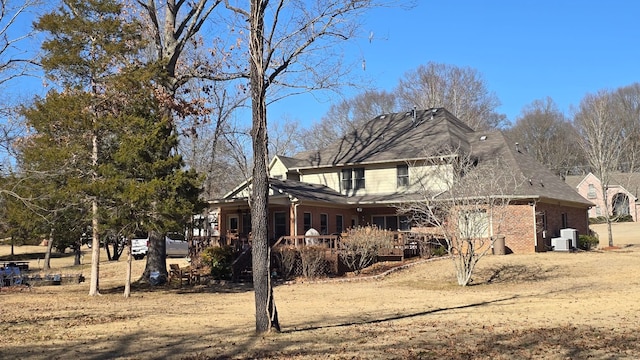 exterior space with a wooden deck and central AC unit